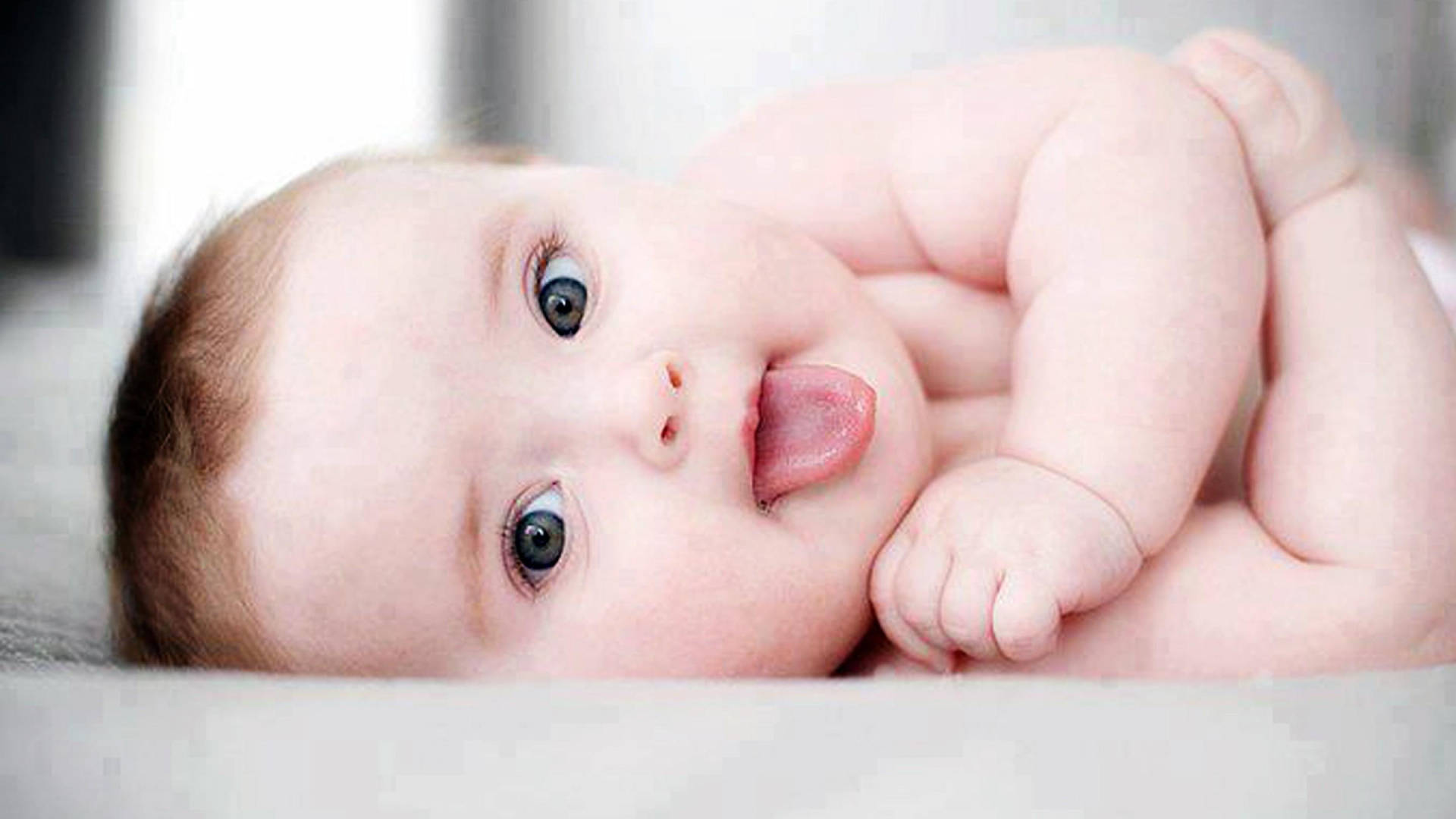 Cool Cute Baby With Tongue Out Wallpaper