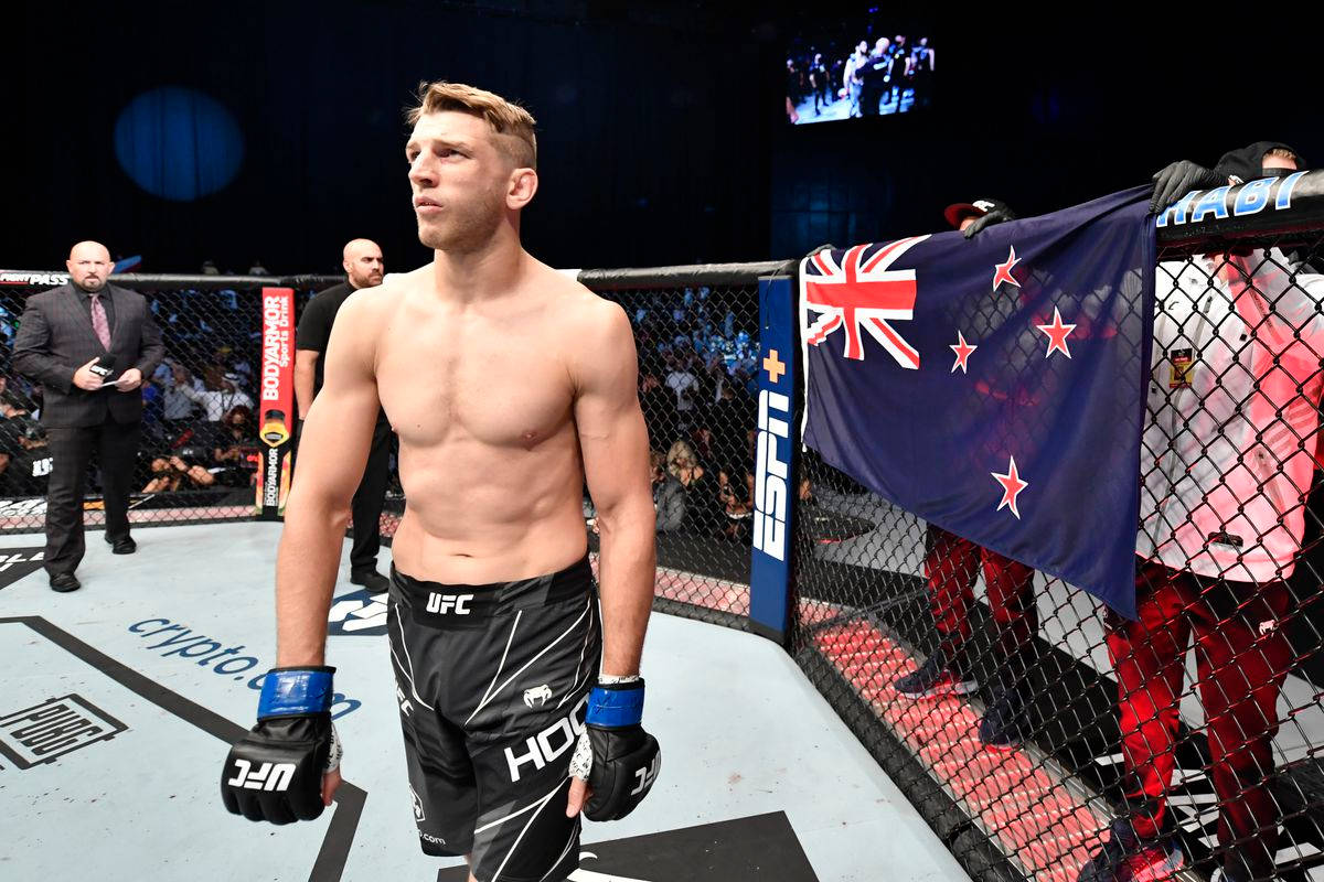 Dan Hooker With Nz Flag On Octagon Wallpaper