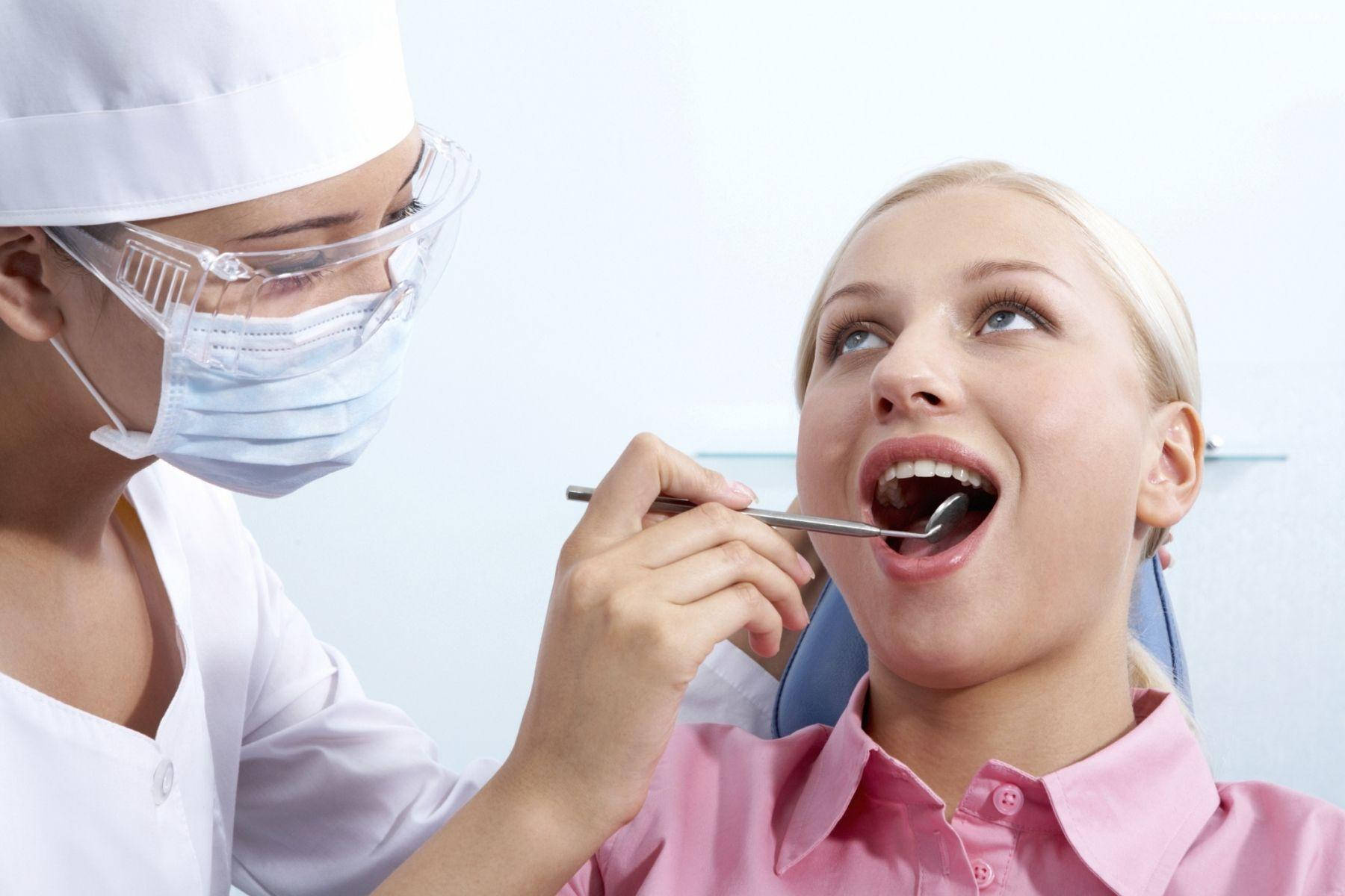 Dedicated Dentist Performing A Routine Check-up Wallpaper