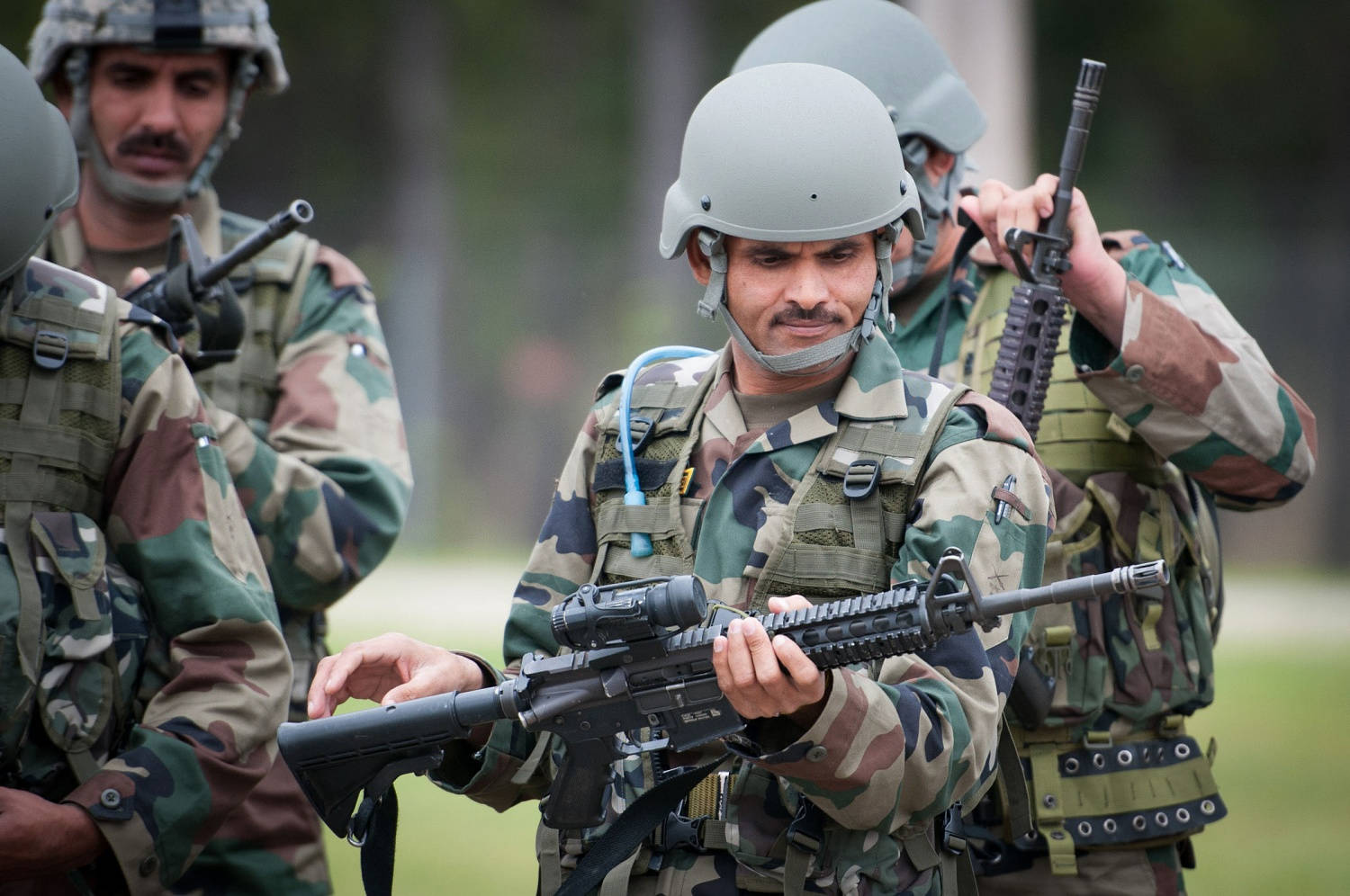 Dedicated Forces Of The Indian Army Inspecting Firearms Wallpaper