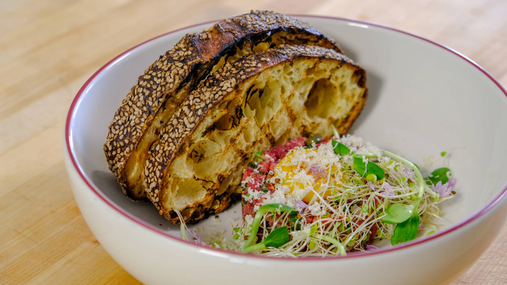 Delicately Prepared Steak Tartare With Vibrant Salad Wallpaper