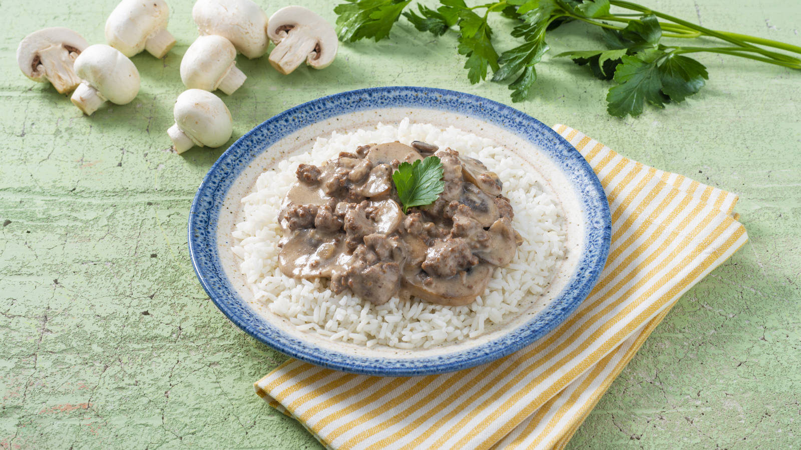 Delicious Beef Stroganoff With Mushrooms Served Over Rice Wallpaper