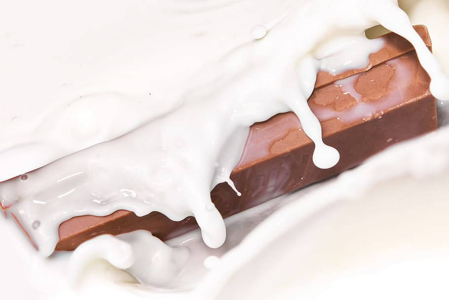 Delicious Kit Kat Chocolate Bars Dipped In Creamy Milk Wallpaper