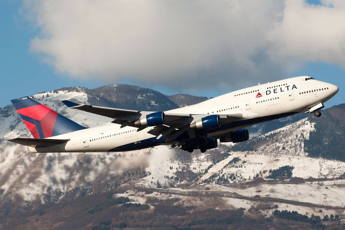 Delta Airlines Airplane Flying By Mountains Wallpaper