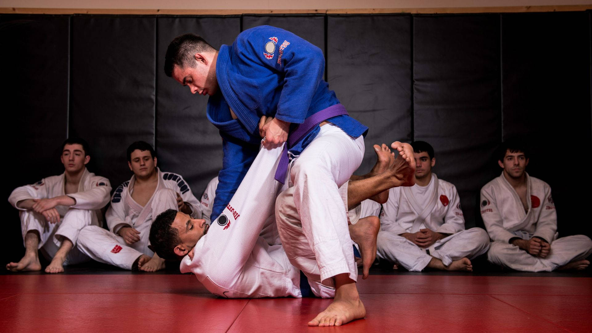 Disciplined And Focused Jiu-jitsu Fighters In Action Wallpaper