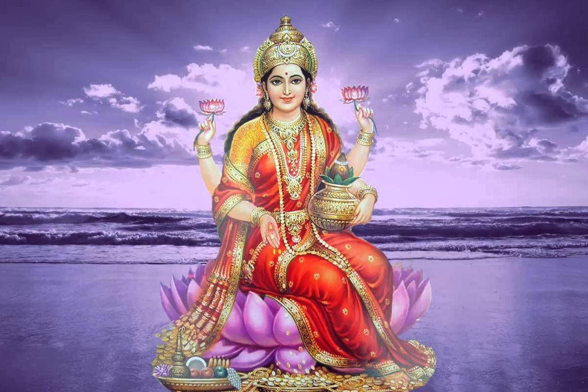 Divine Beauty Of Lakshmi With Purple Lotus Wallpaper