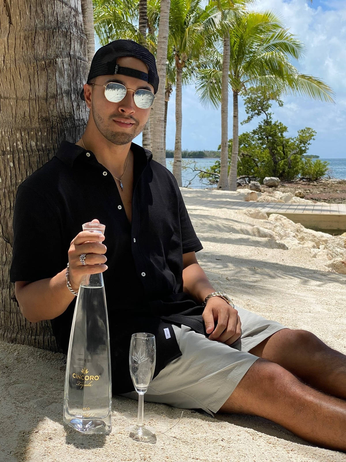 Dj Crespo With Cincoro Tequila At Beach Wallpaper