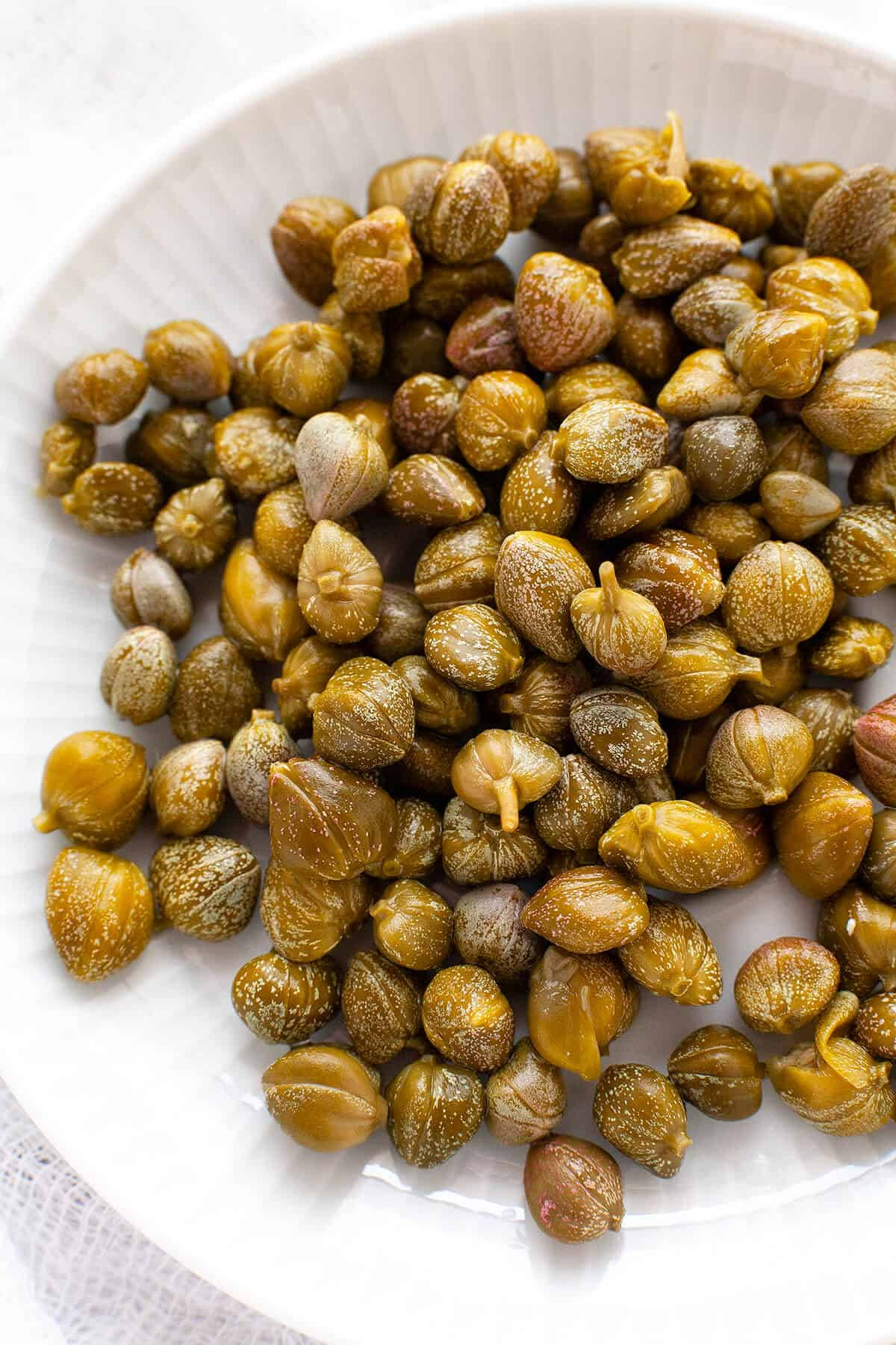 Dried Capers Elegantly Served On A Plate Wallpaper