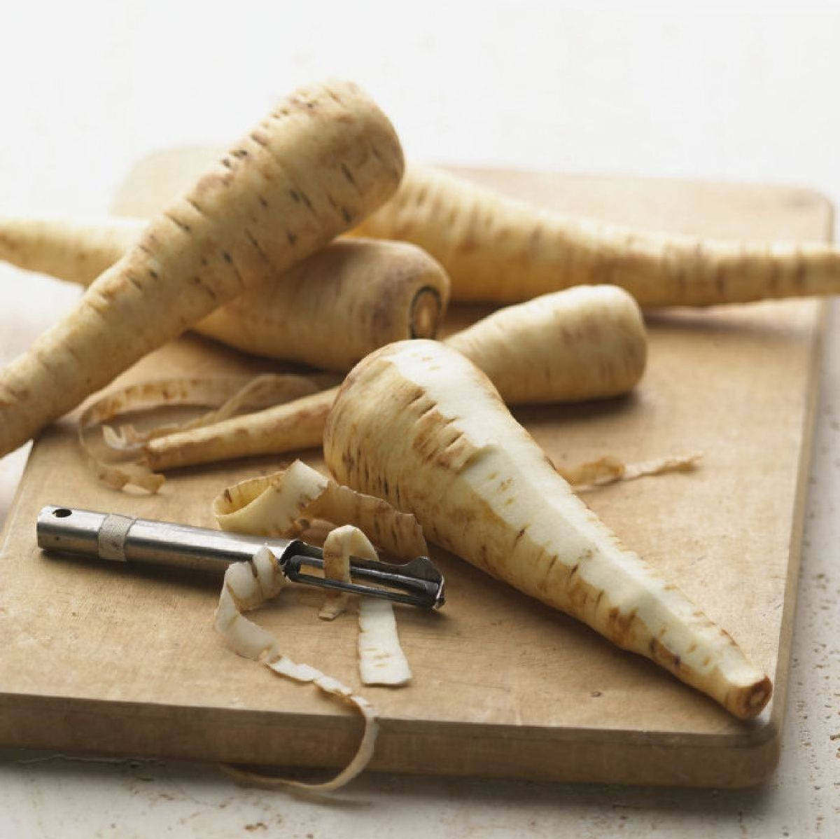 Dry Peeled Parsnip Vegetables On Chop Board Wallpaper