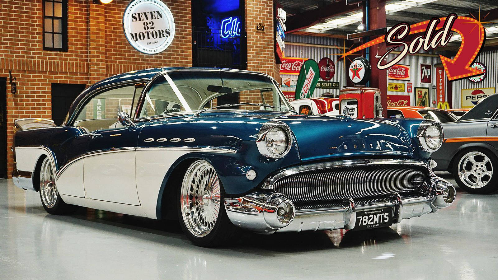 Elegant Restored Buick Special Showcased In An Upscale Showroom Wallpaper