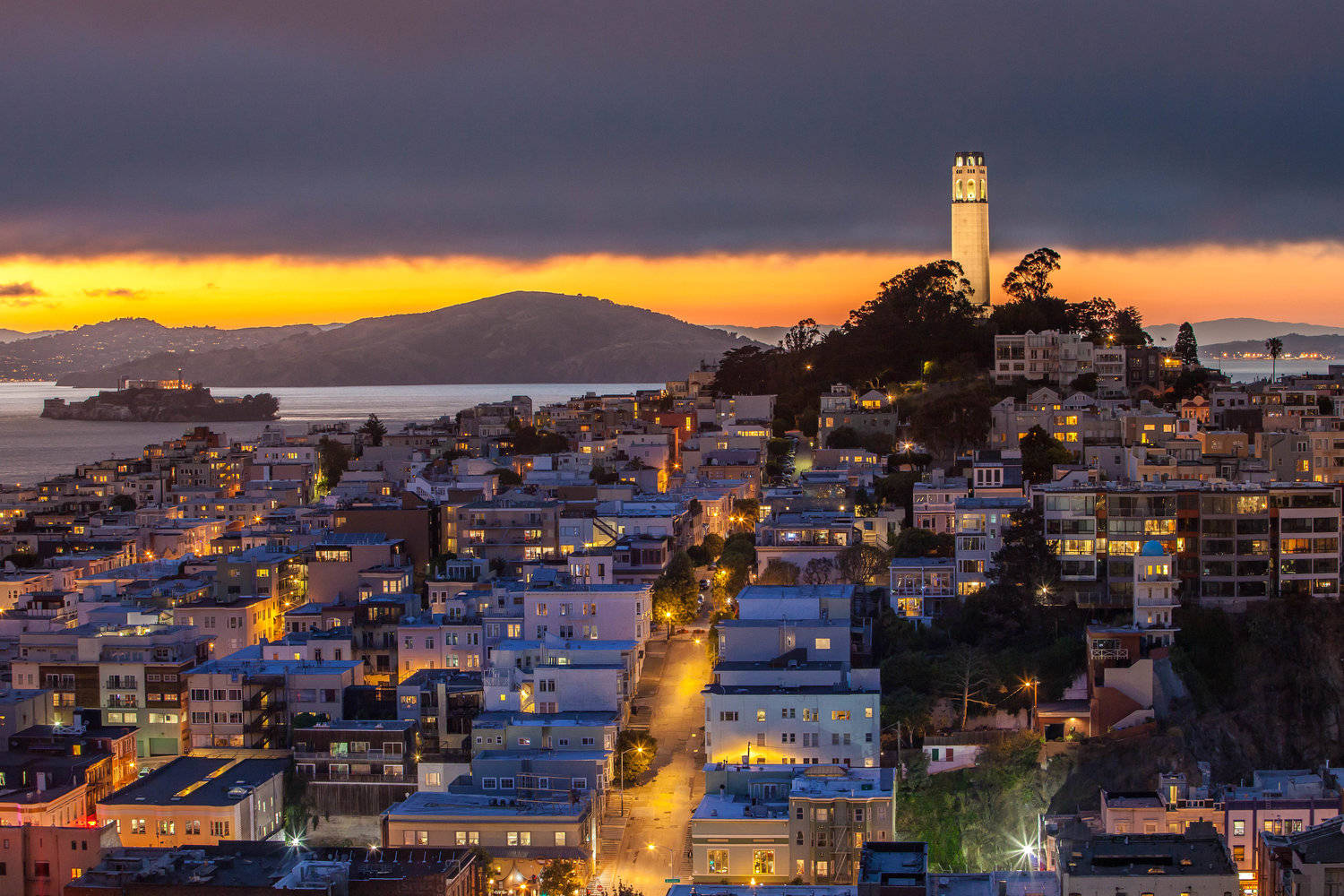 Enjoy The Vibrant Night Sky And Stunning Views From Coit Tower! Wallpaper