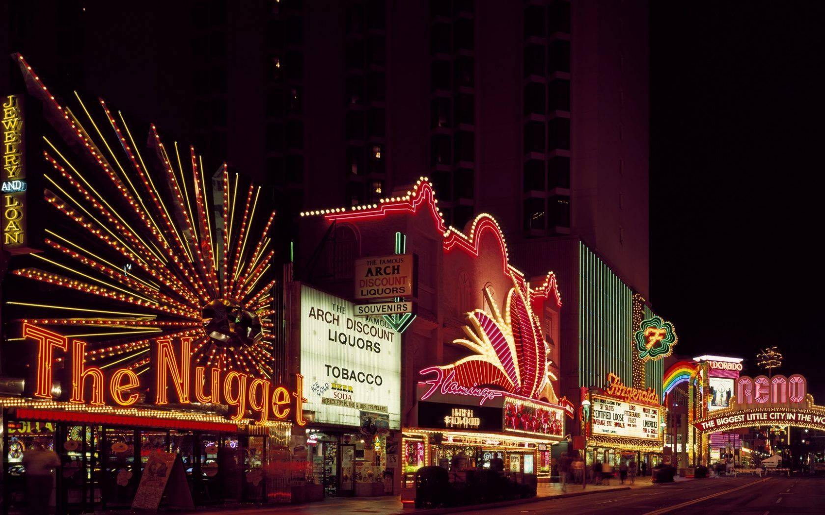 Enjoying The Vibrant Lights Of Reno's Strip At Night Wallpaper