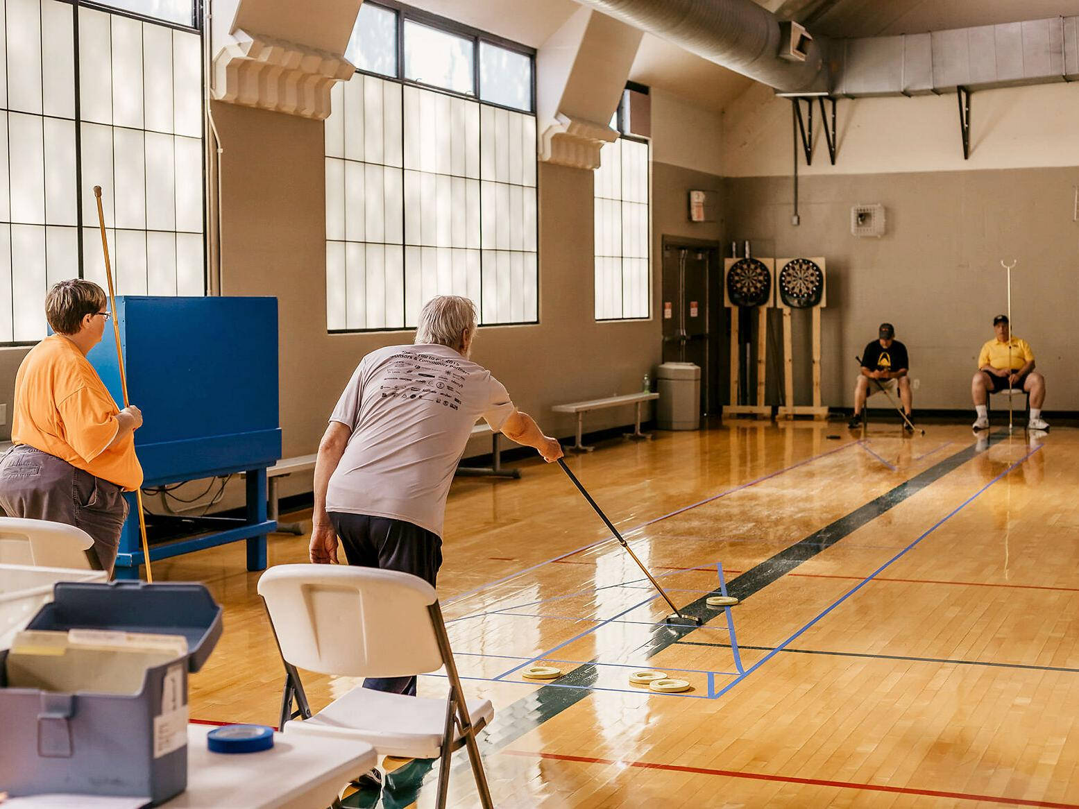 Excitement On The Court: A Game Of Indoor Floor Shuffleboard Wallpaper