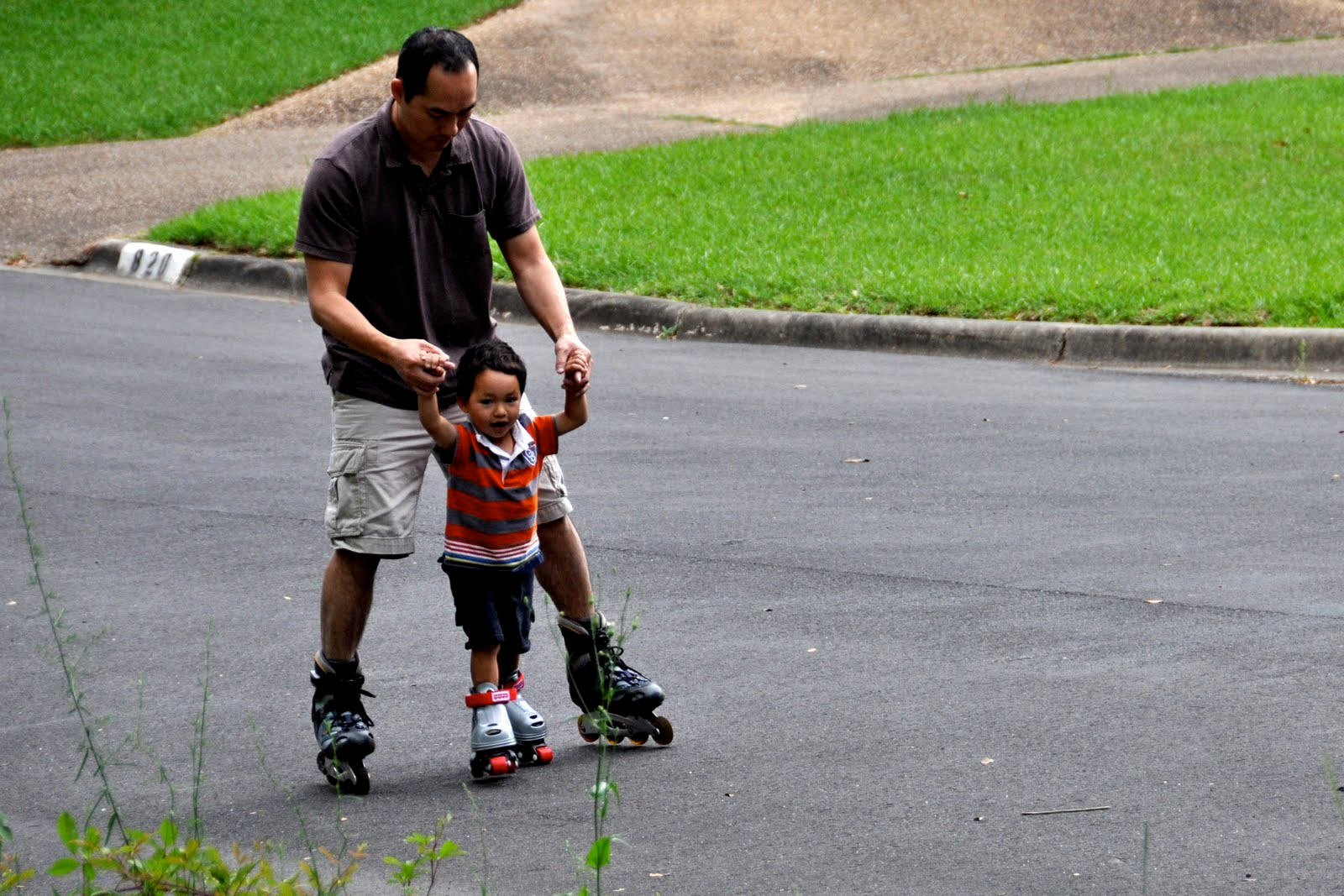 Father Teaching Son Rollerblading Wallpaper