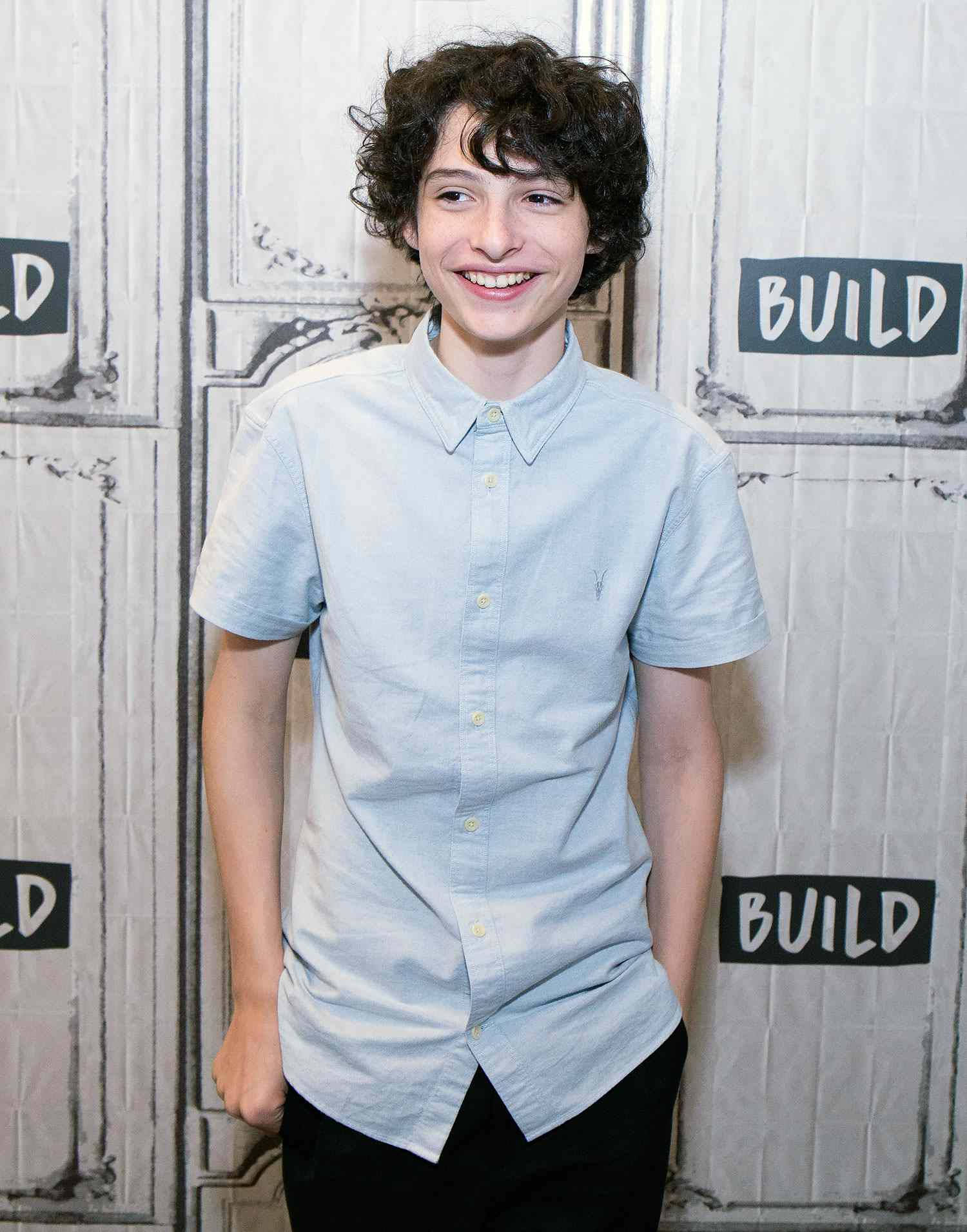 Finn Wolfhard In White Shirt Wallpaper