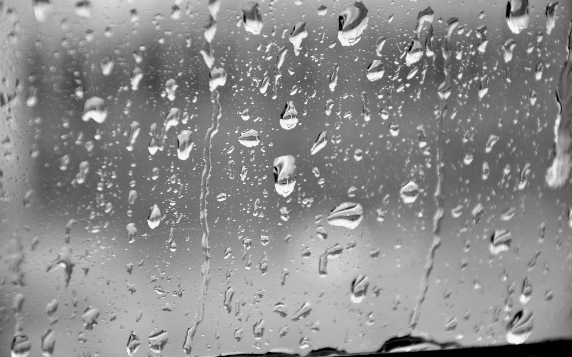 Flowing Raindrops On Glass Surface Greyscale Wallpaper