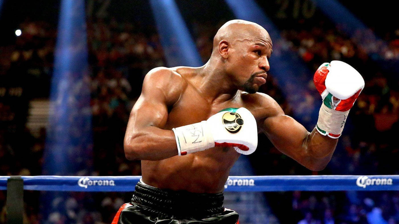 Floyd Mayweather Raising His Boxing Gloves Wallpaper