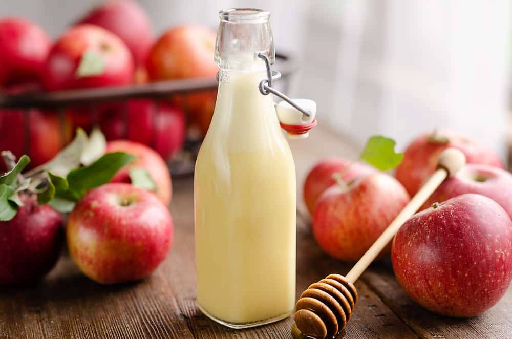 Fresh Apple Cider Vinegar In A Glass Bottle Wallpaper