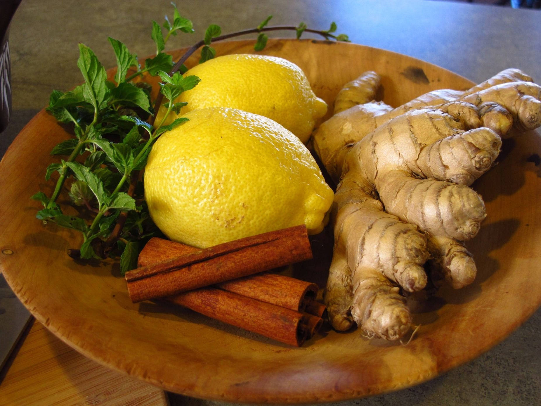 Fresh Ginger Root With Zesty Lemons And Cinnamon Sticks Wallpaper