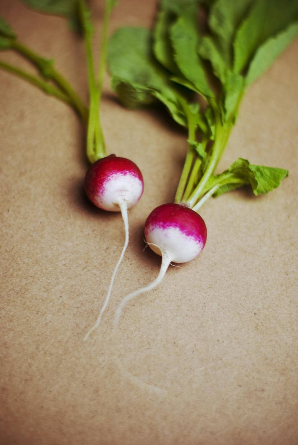 Fresh Uncut Radish Lying On A Cork Surface. Wallpaper