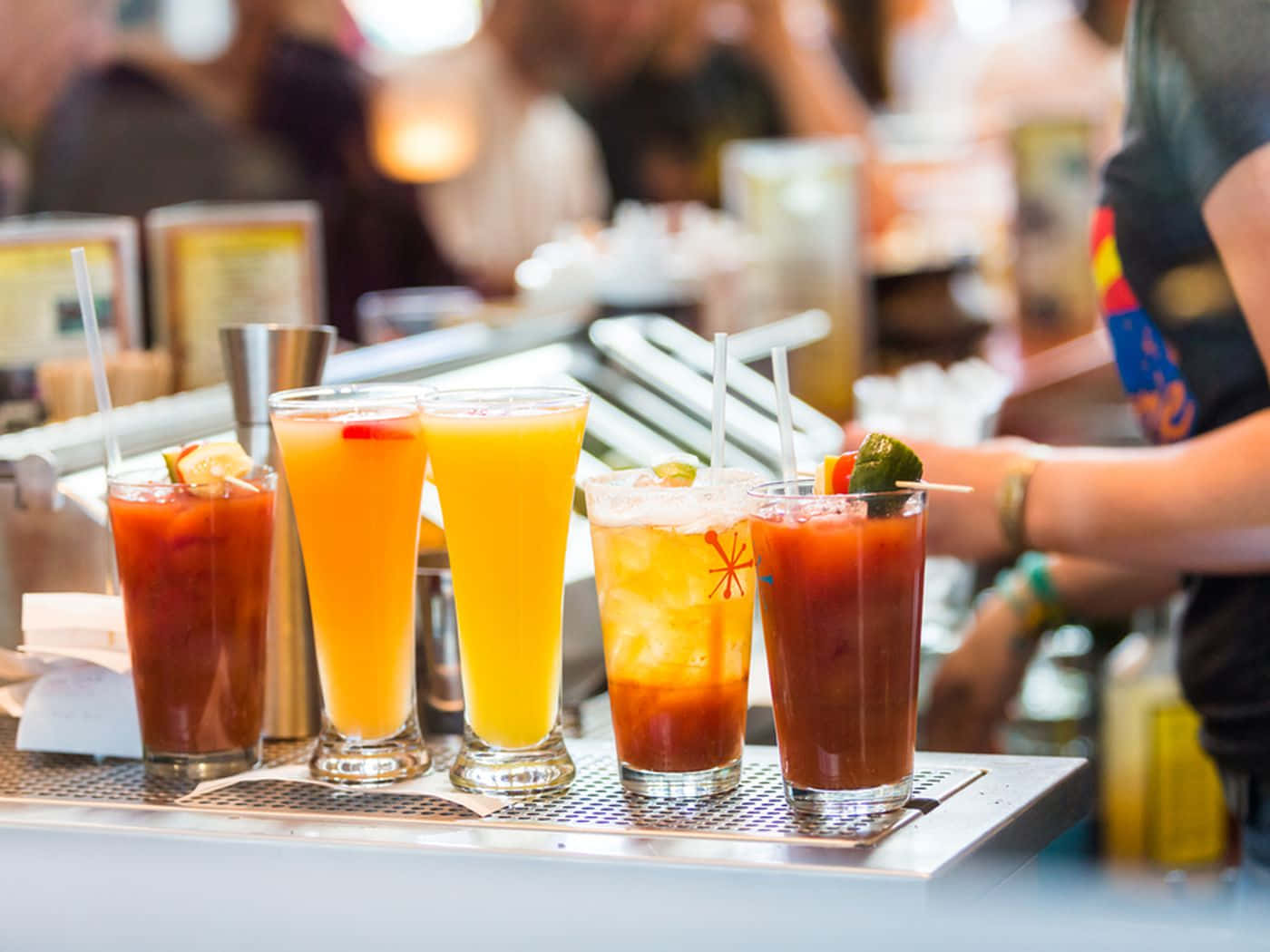 Glasses Of Cocktail Drinks On Metal Counter Wallpaper