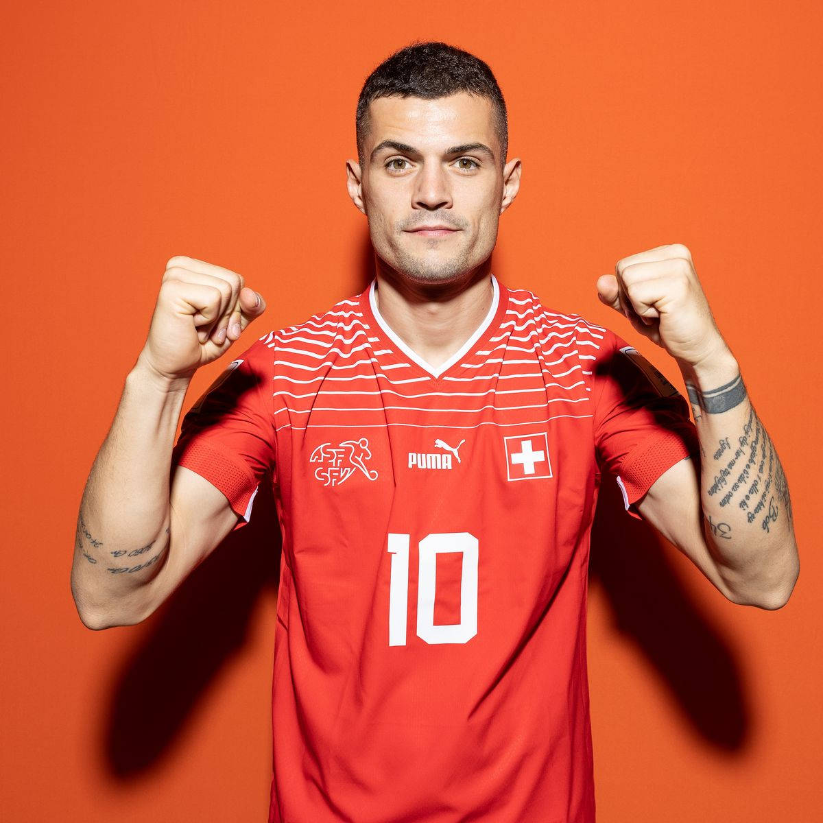 Granit Xhaka Orange Background Wallpaper