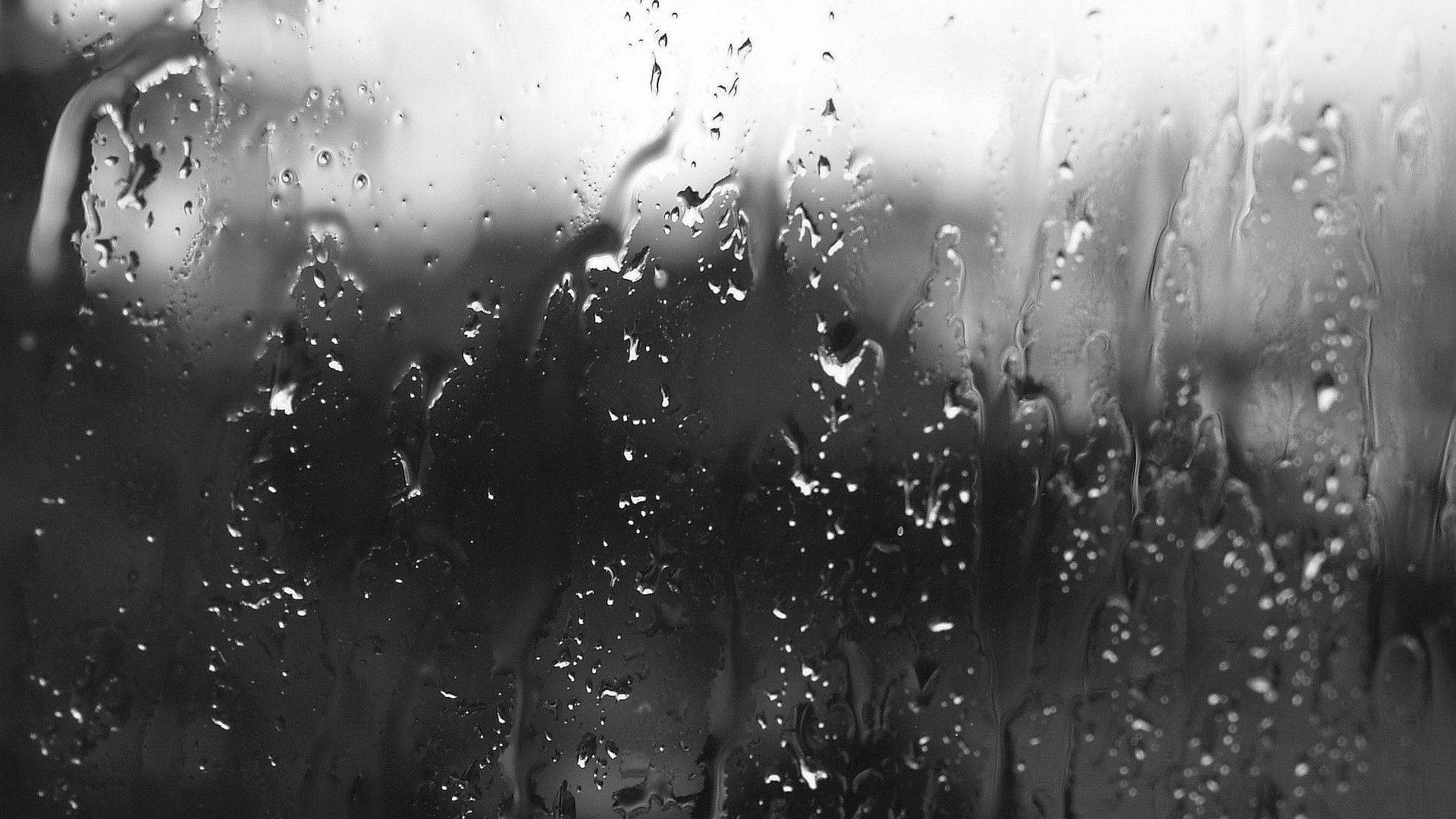 Greyscale Falling Raindrops On A Glass Pane Wallpaper