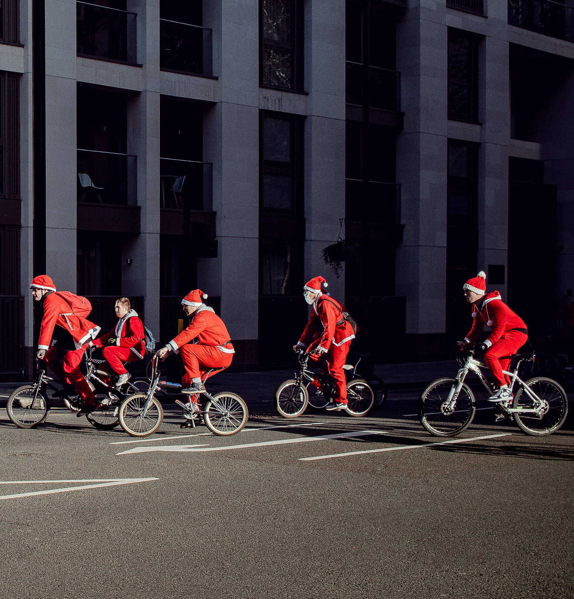 Group Of People In Santa Costumes Wallpaper