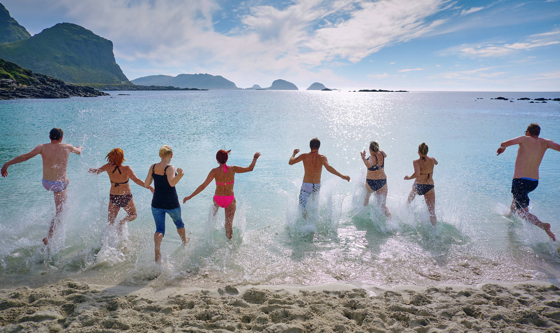 Group Of People Running To The Water Wallpaper