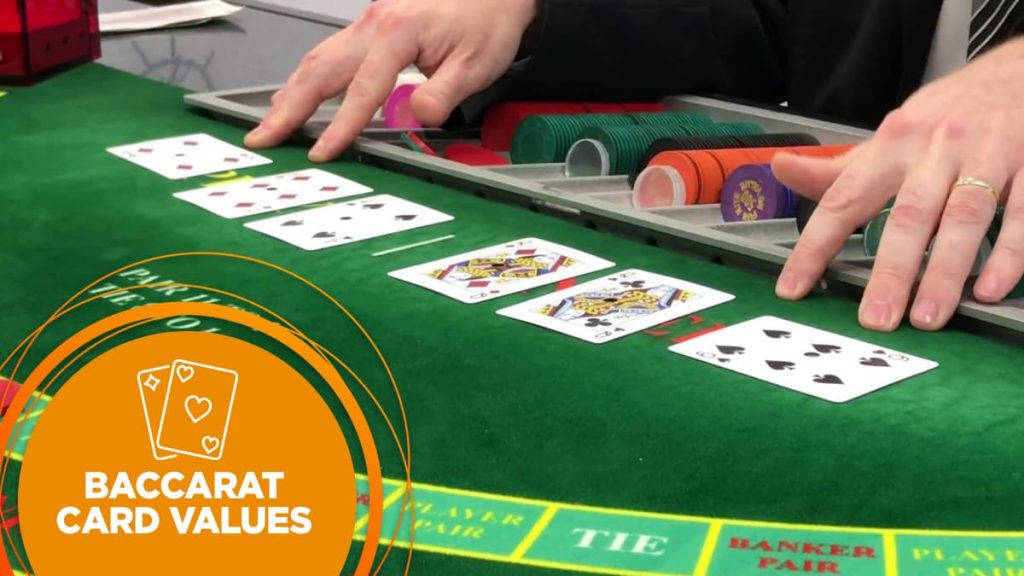 Hands Examining The Cards Laid Out In A Baccarat Wallpaper