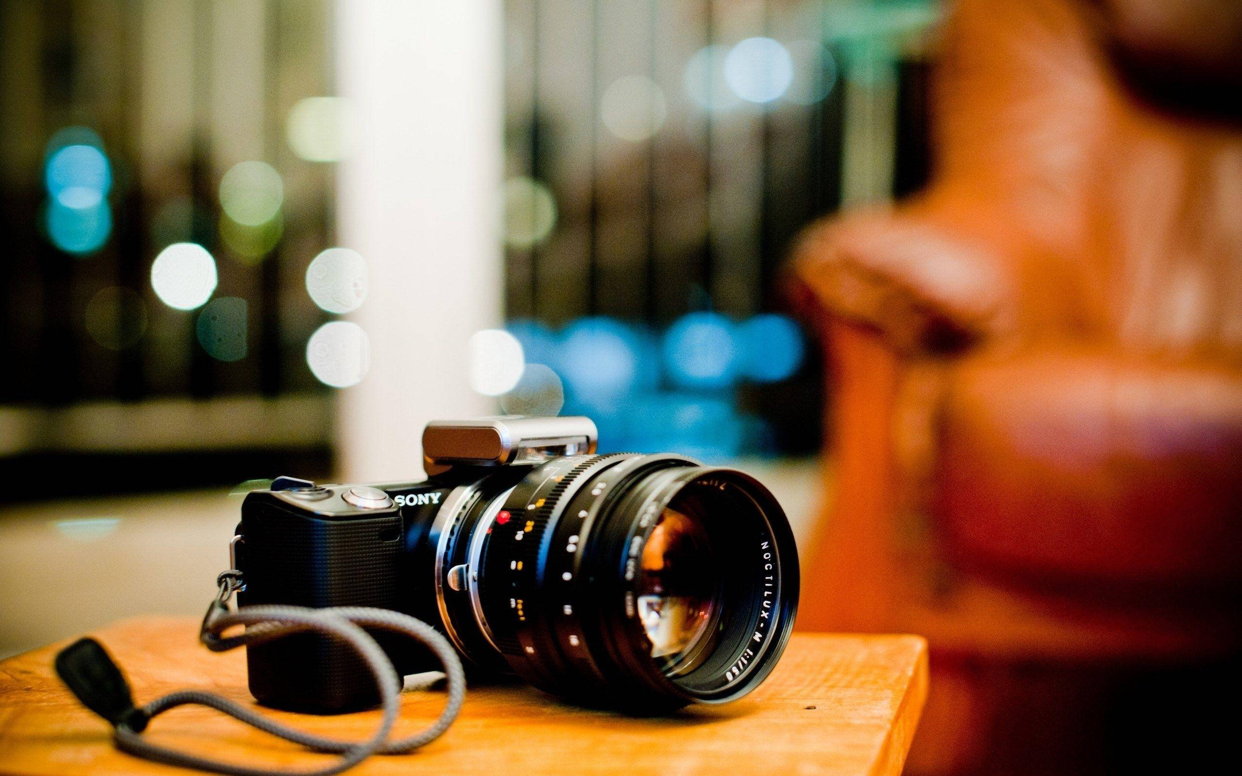 Hd Camera On A Wooden Table Wallpaper