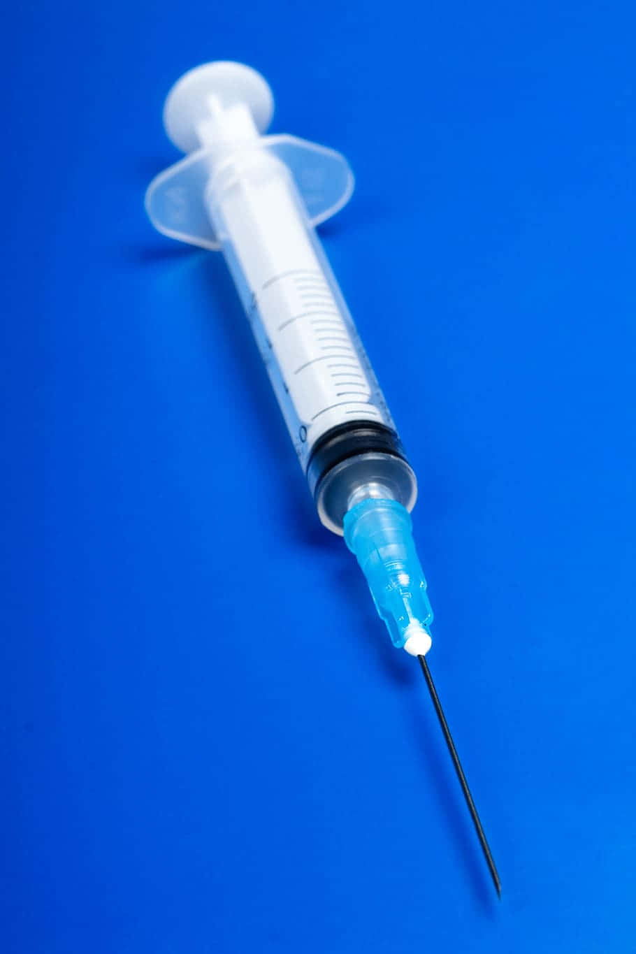 Hd Medical Syringe On Blue Background Wallpaper