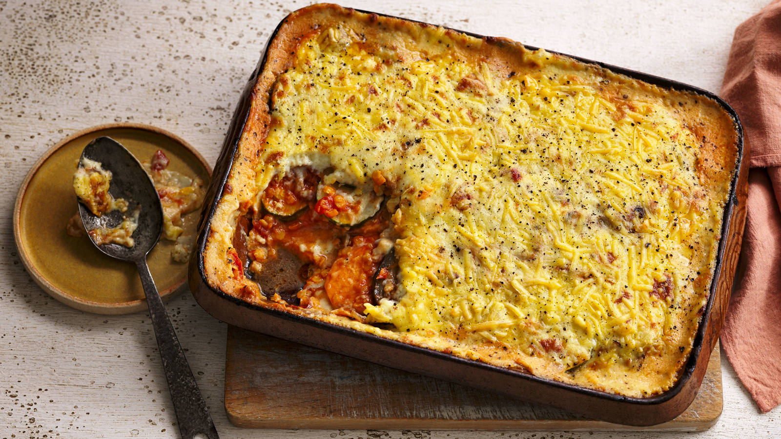 Hearty Tray Of Homemade Baked Moussaka With A Portion Eaten Wallpaper