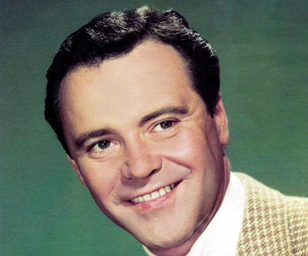 Hollywood Legend Jack Lemmon Posing Confidently In Front Of A Green Background Wallpaper