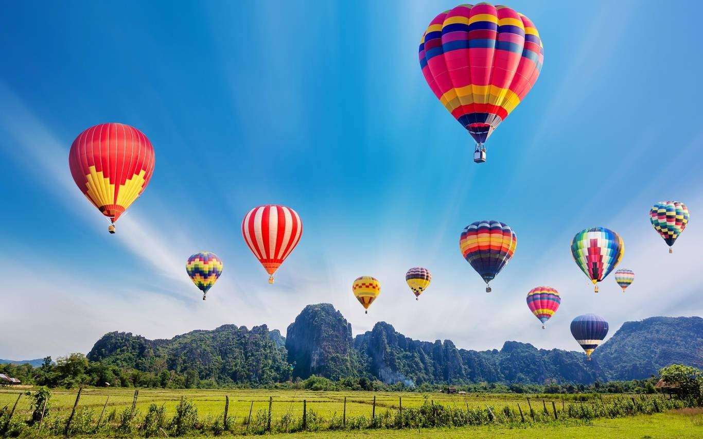 Hot Air Balloon Over A Crop Field Wallpaper