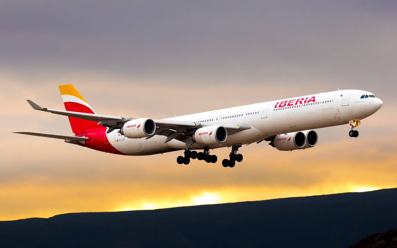 Iberia Airlines Airplane Takeoff At Sunset Wallpaper