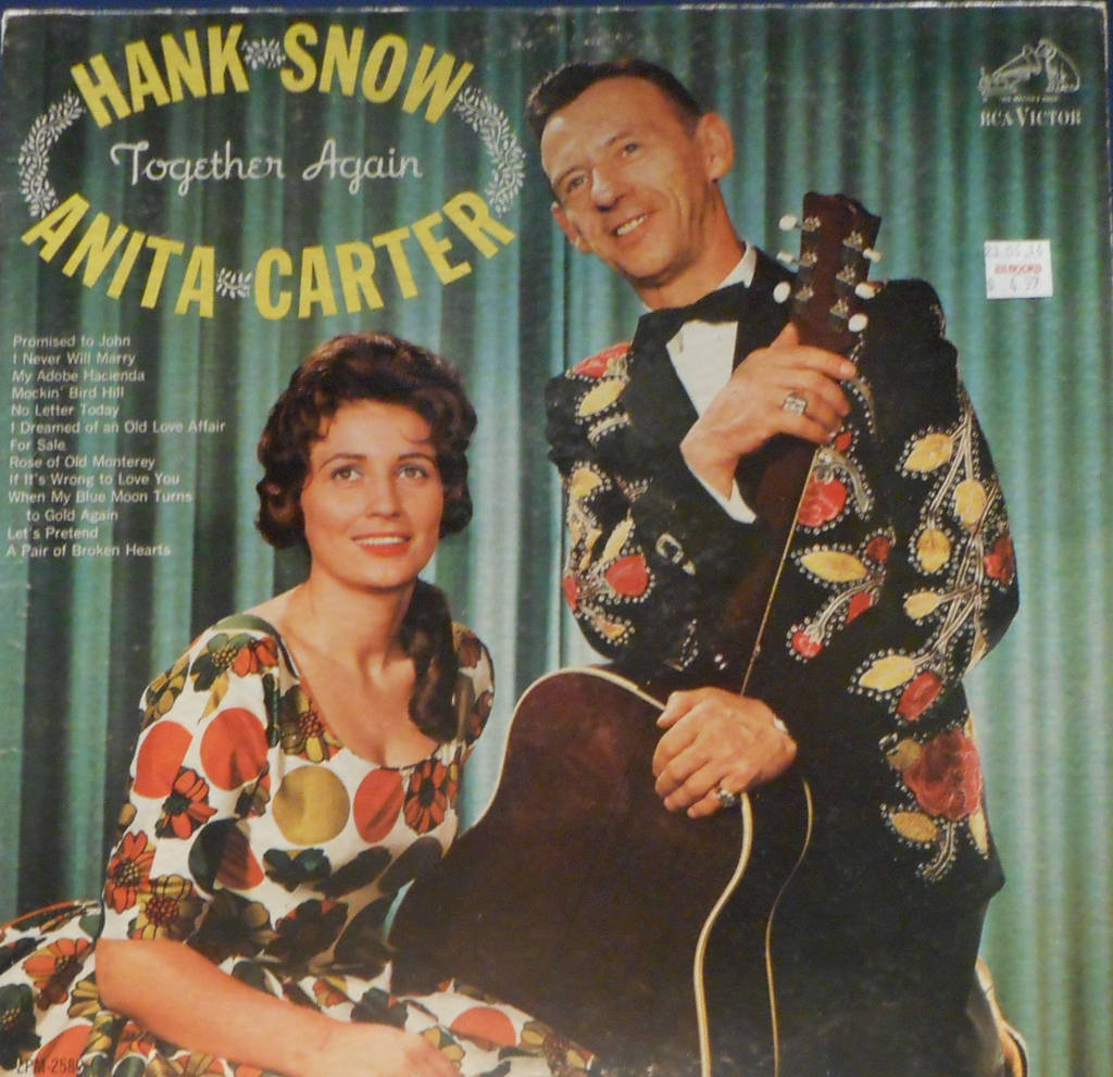 Iconic Country Singers Hank Snow And Anita Carter Performing Together Wallpaper