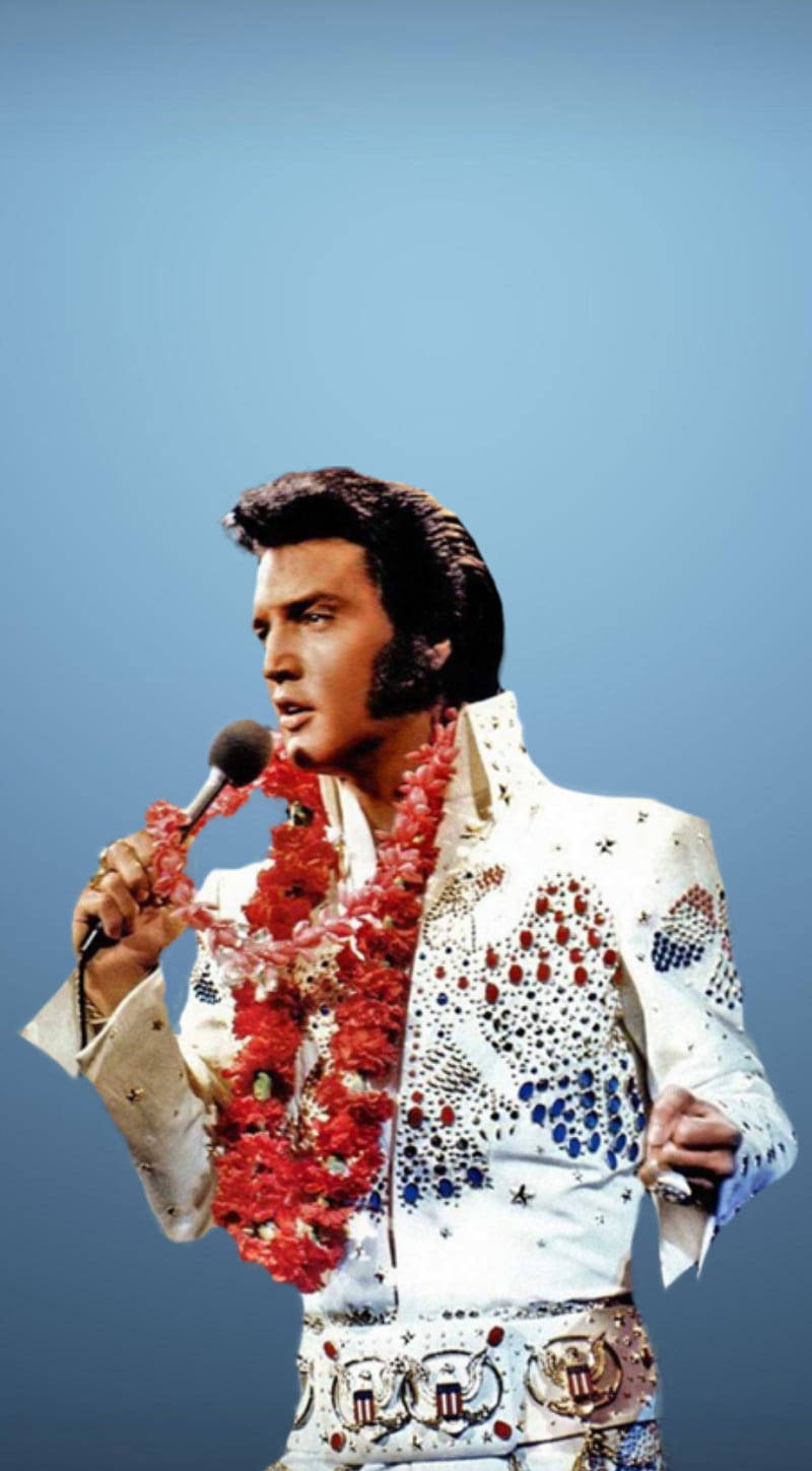 Iconic Image Of Elvis Presley Against A Striking Blue Backdrop Wallpaper