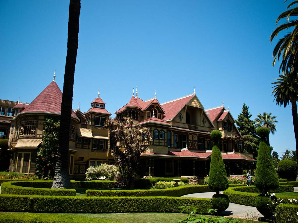 Iconic Winchester Mystery House With Beautiful Topiaries Wallpaper