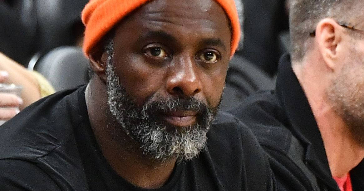 Idris Elba Wearing An Orange Bonnet Wallpaper