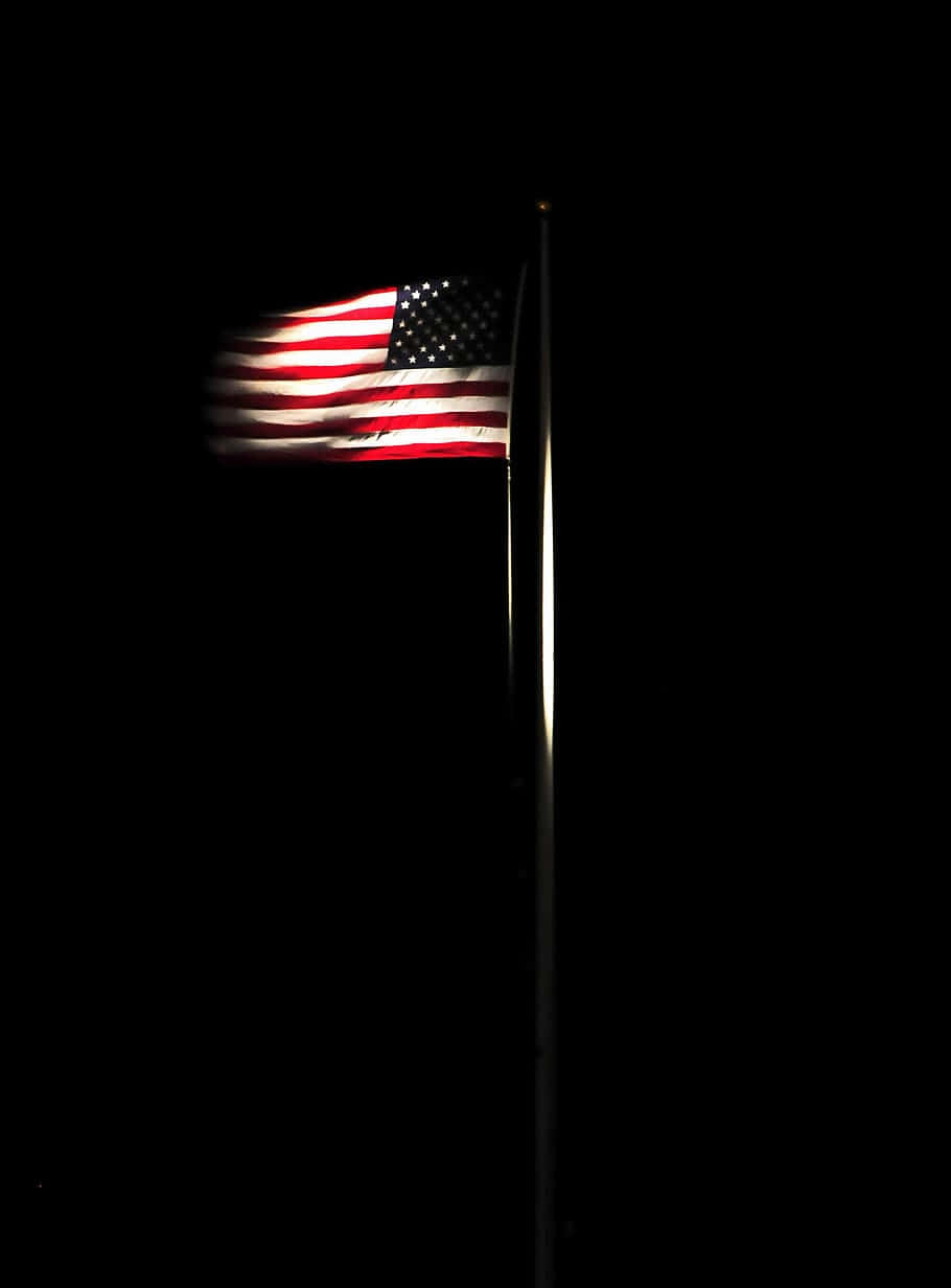 Illuminated American Flagin Darkness.jpg Wallpaper