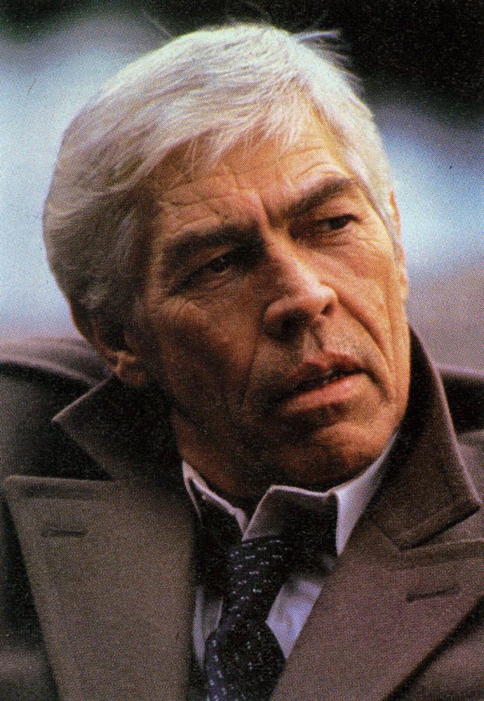 James Coburn In A Trench Coat Wallpaper