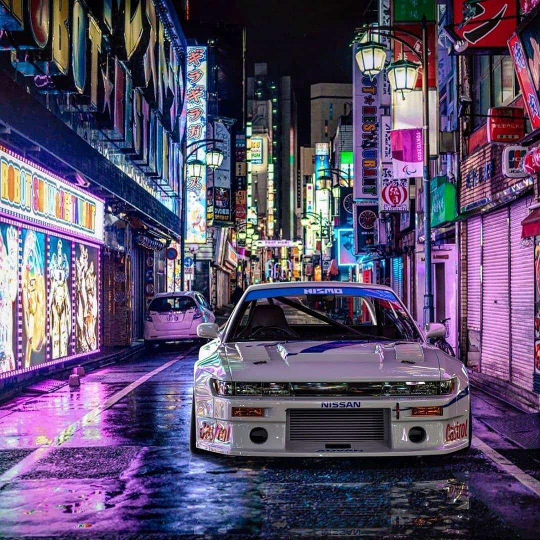 Jdm Cars On Colorful Side Street Wallpaper