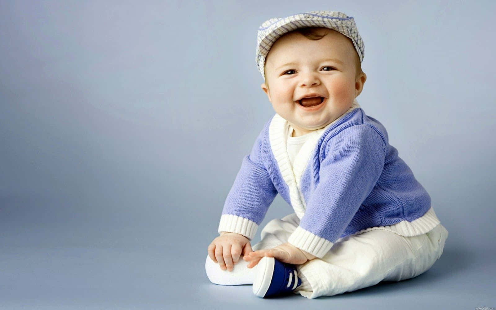 Joyful Babyin Blue Sweaterand Cap Wallpaper