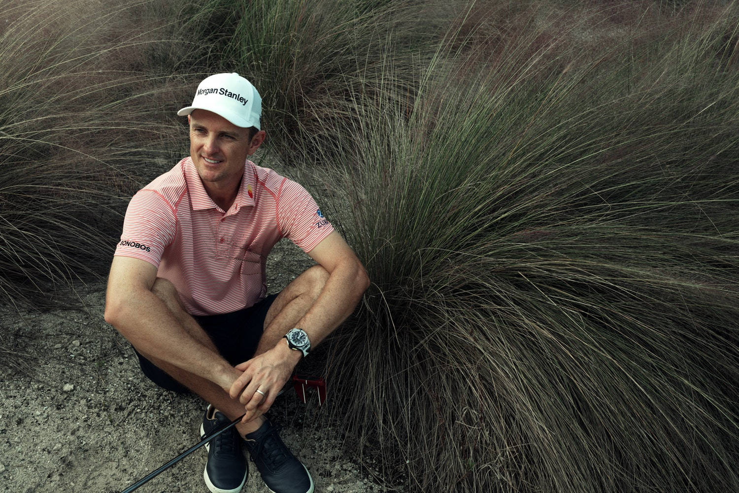 Justin Rose Sitting Beside A Bush Wallpaper