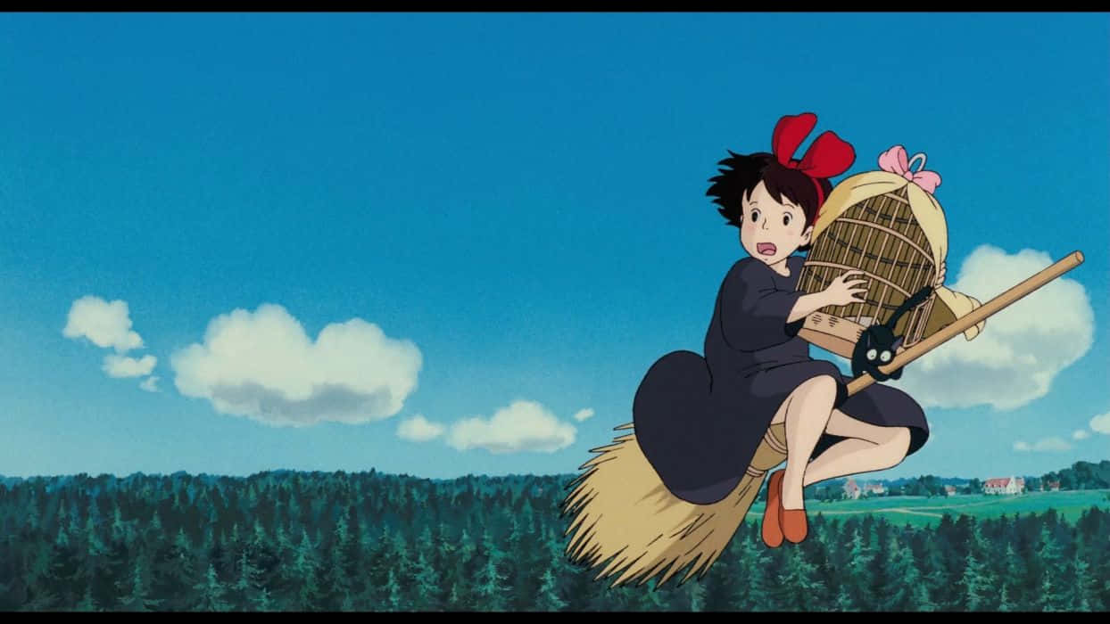 Kiki Flying On Her Broom With Jiji Over The Picturesque Coastal Town Wallpaper