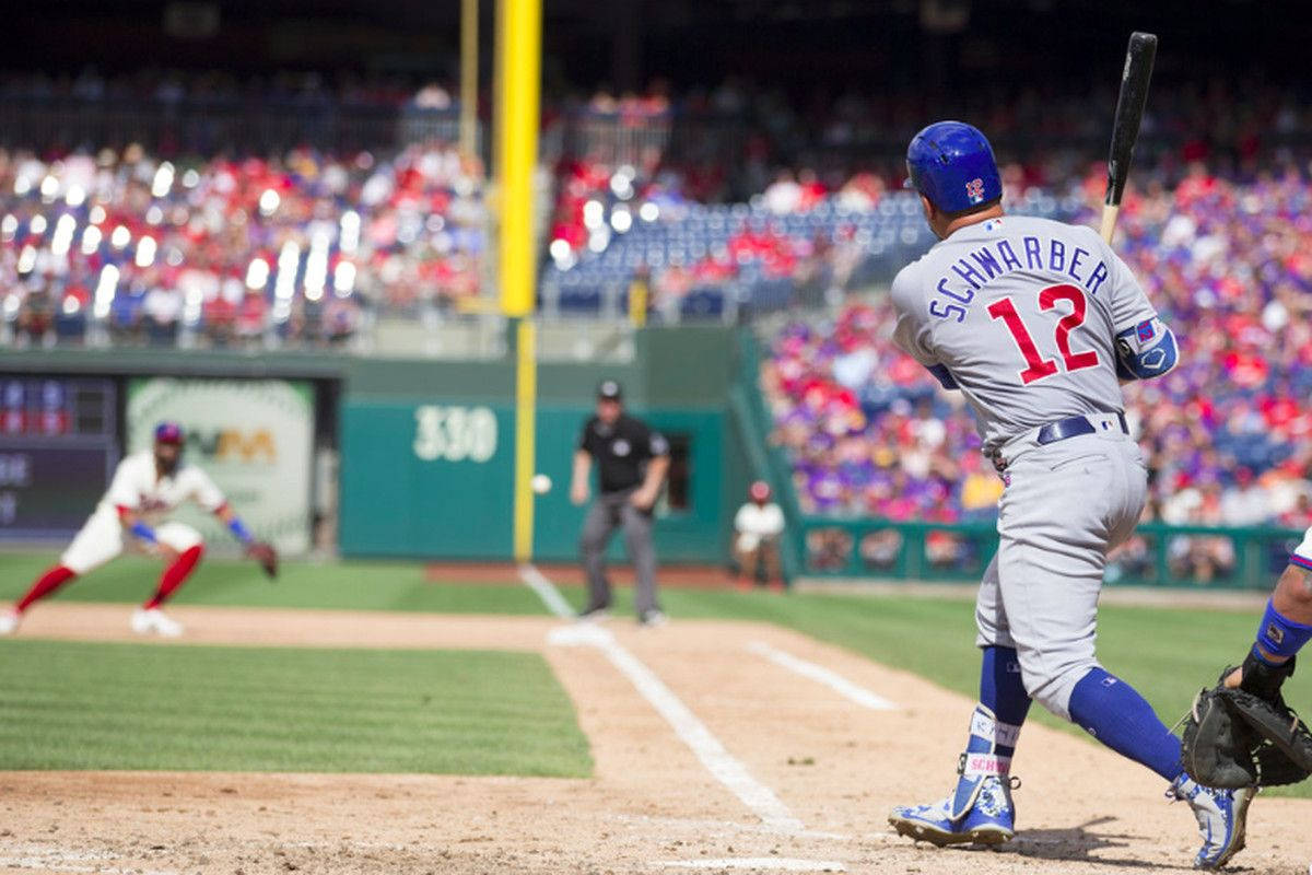 Kyle Schwarber Swinging For The Fences Wallpaper