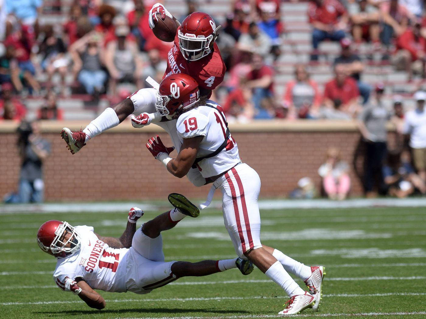 Kyler Murray Jumping Over Teammates Wallpaper