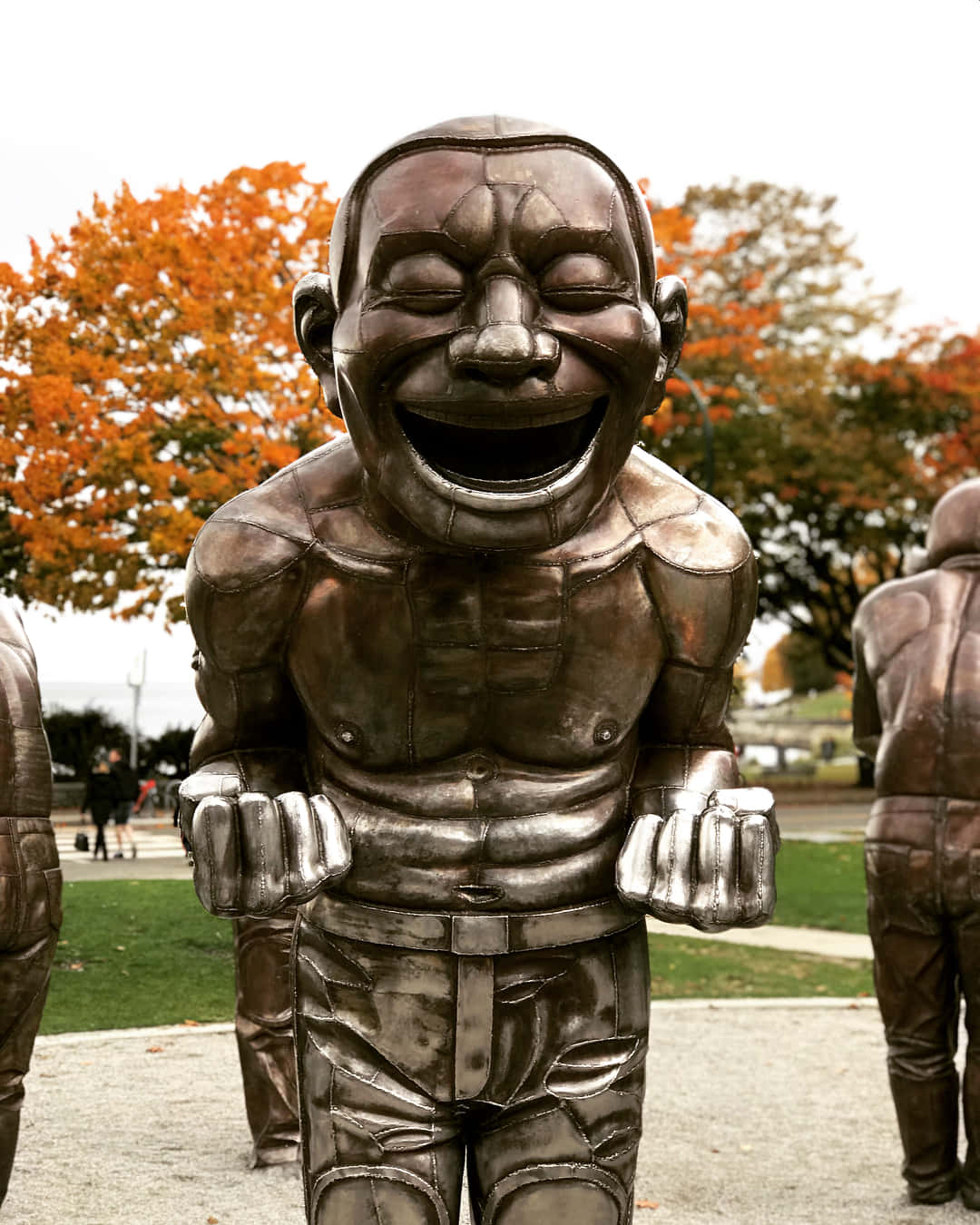 Laughing Statue Autumn Backdrop Wallpaper