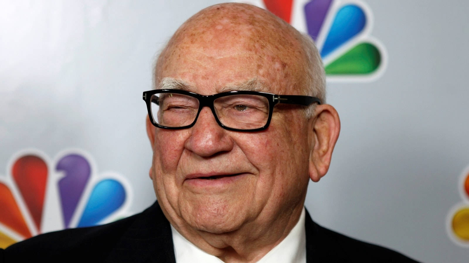 Legendary Actor Edward Asner With Nbc Logo Wallpaper